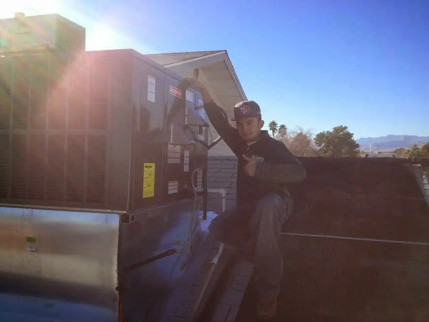 HVAC technician performing Air Duct Cleaning on a rooftop unit in Hellam